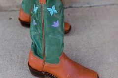 "The Garden Boot" are women's cowboy boots with butterfly and wildflower inlays