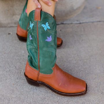 "The Garden Boot" are women's cowboy boots with butterfly and wildflower inlays